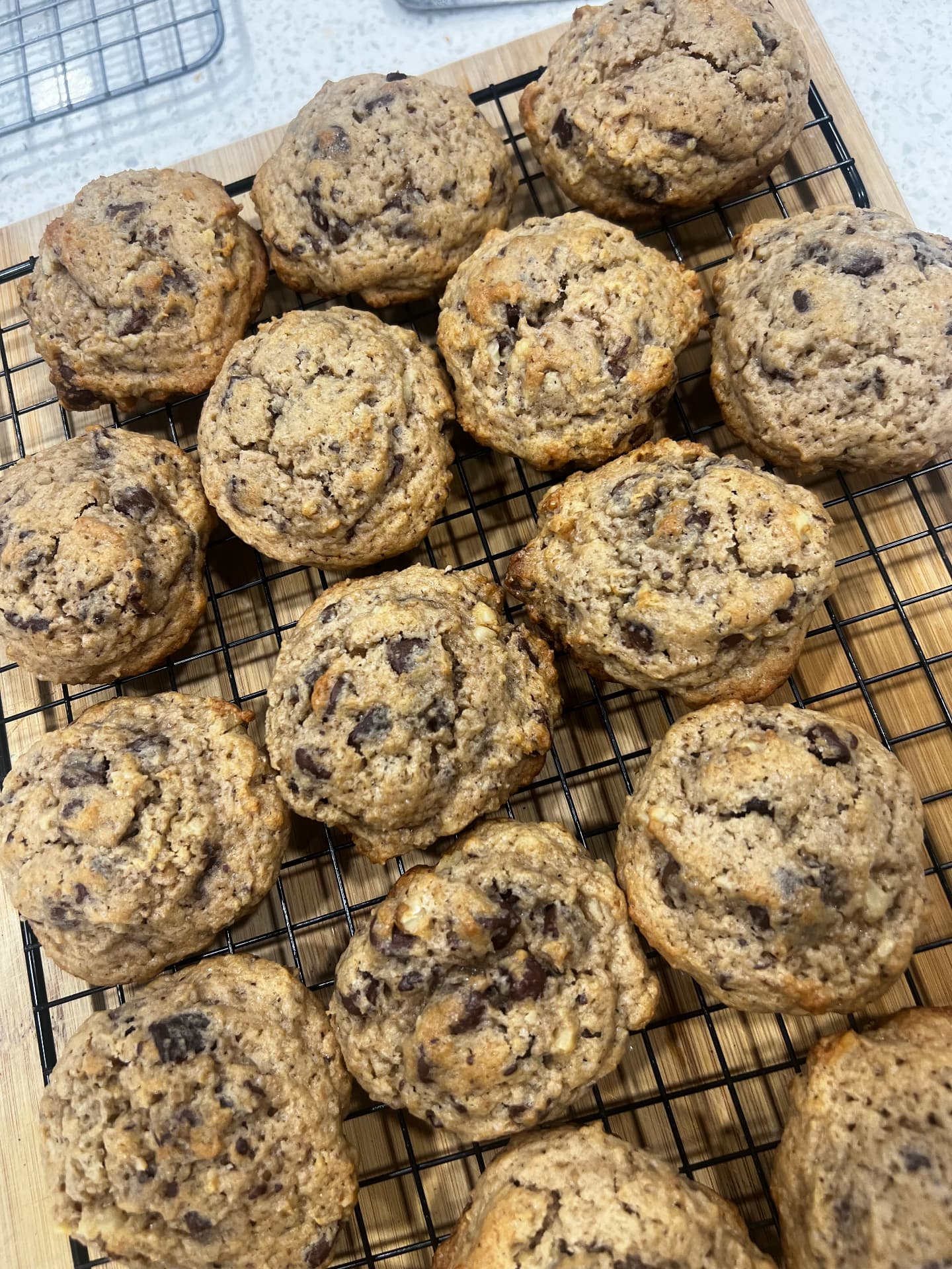 Tray of sourdough chocolate chip cookies on a cooling rack